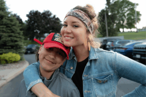 Two individuals hugging and smiling